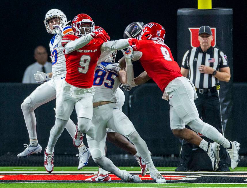 UNLV defensive back Jett Elad (9) breaks up a touchdown pass to Boise State Broncos tight end M ...