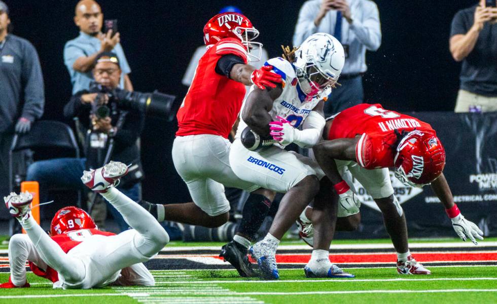 Boise State Broncos running back Ashton Jeanty (2) nearly fumbles the ball after a hit by UNLV ...