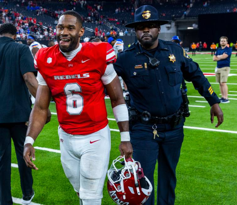 UNLV quarterback Hajj-Malik Williams (6) is escorted off the field after a gritty performance a ...