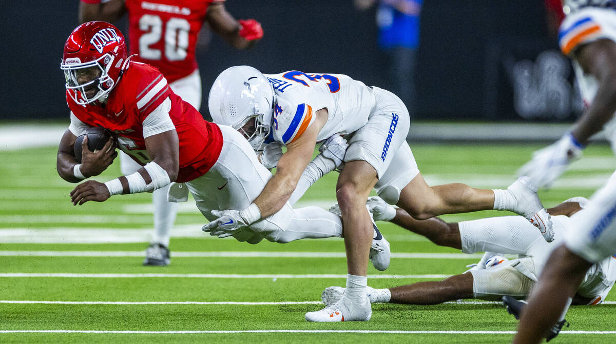 UNLV quarterback Hajj-Malik Williams (6) is finally stopped after a run by Boise State Broncos ...