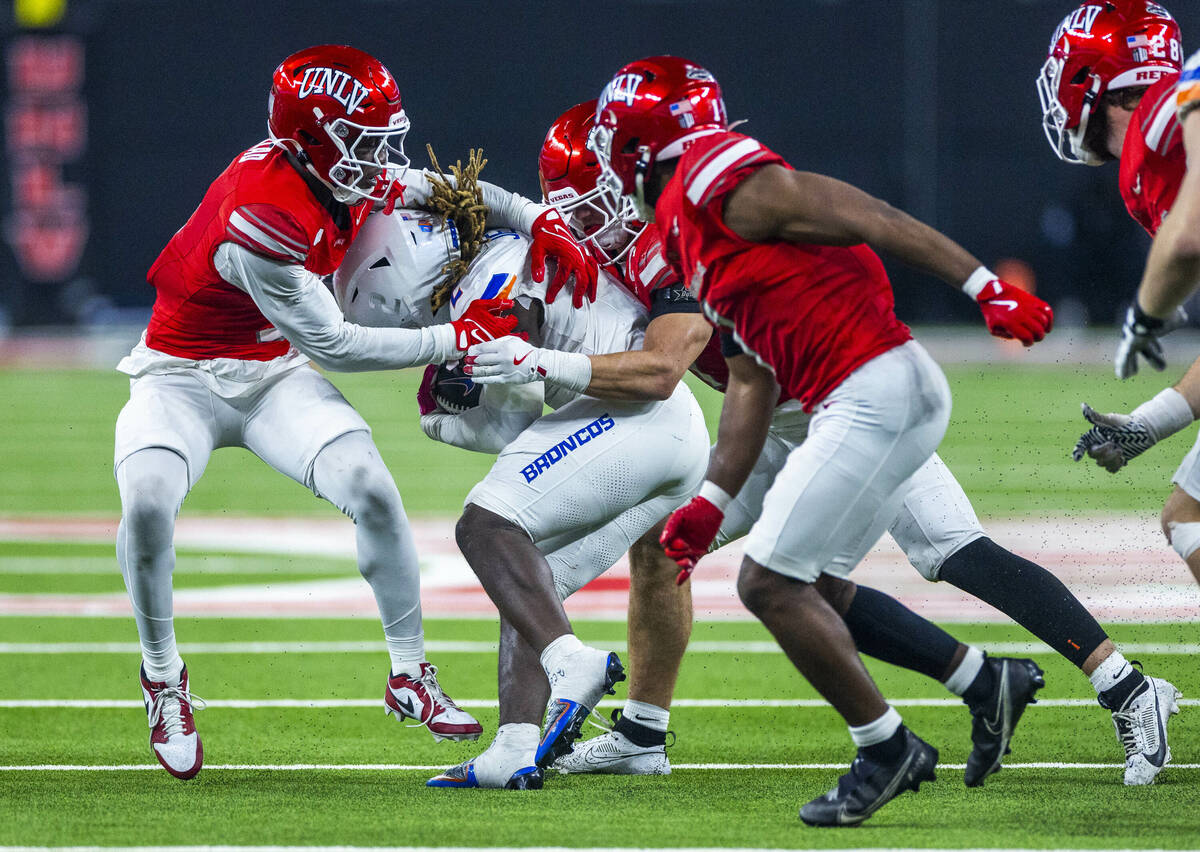 Boise State Broncos running back Ashton Jeanty (2) is gang tackled again by UNLV defenders duri ...