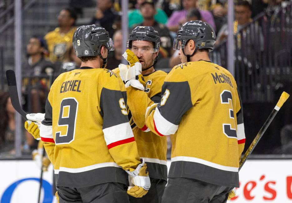 Golden Knights right wing Mark Stone, center, talks to center Jack Eichel (9) and defenseman Br ...