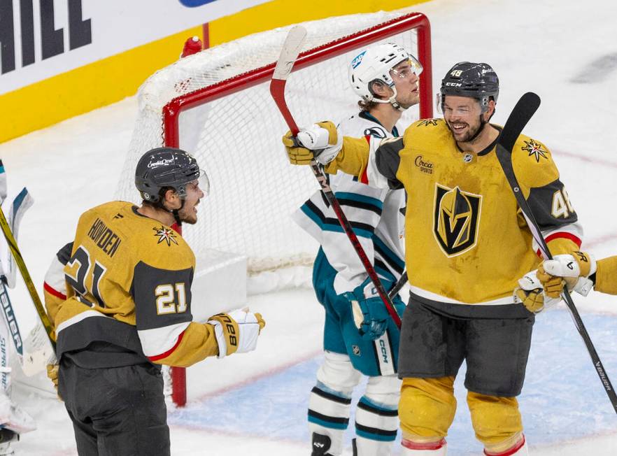 Golden Knights center Tomas Hertl (48) skates toward center Brett Howden (21) to celebrate a go ...