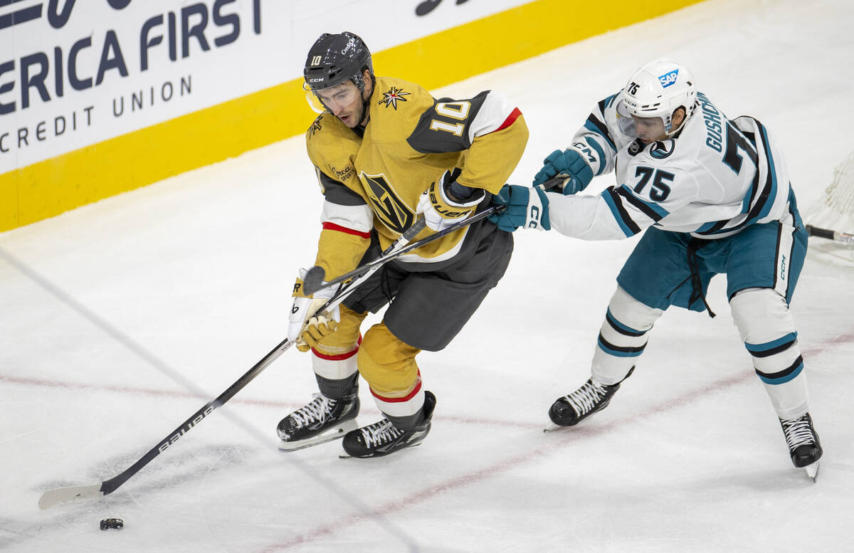 Golden Knights center Nicolas Roy (10) keeps the puck from San Jose Sharks left wing Danil Gush ...