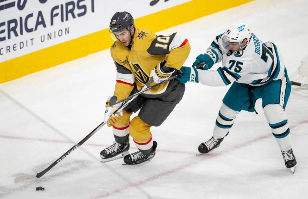 Golden Knights center Nicolas Roy (10) keeps the puck from San Jose Sharks left wing Danil Gush ...