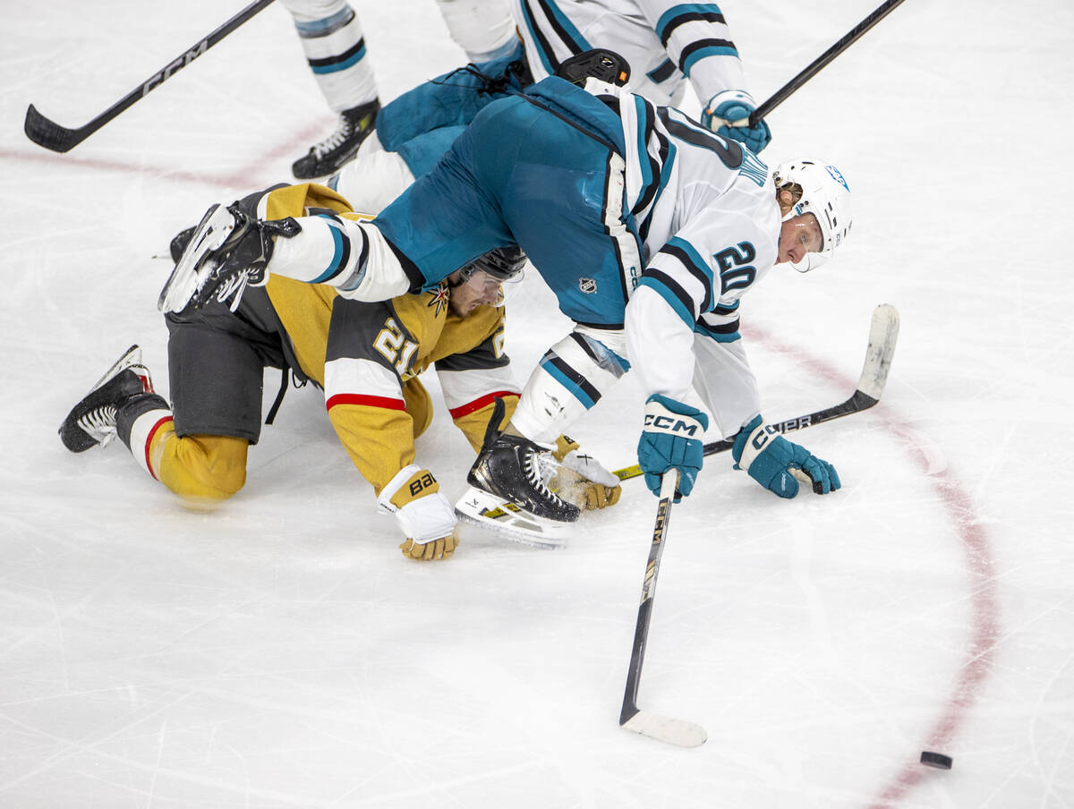 Golden Knights center Brett Howden (21) and San Jose Sharks left wing Fabian Zetterlund (20) fa ...