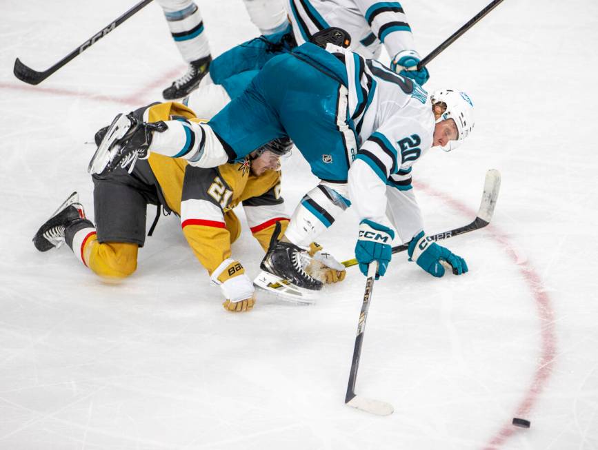 Golden Knights center Brett Howden (21) and San Jose Sharks left wing Fabian Zetterlund (20) fa ...