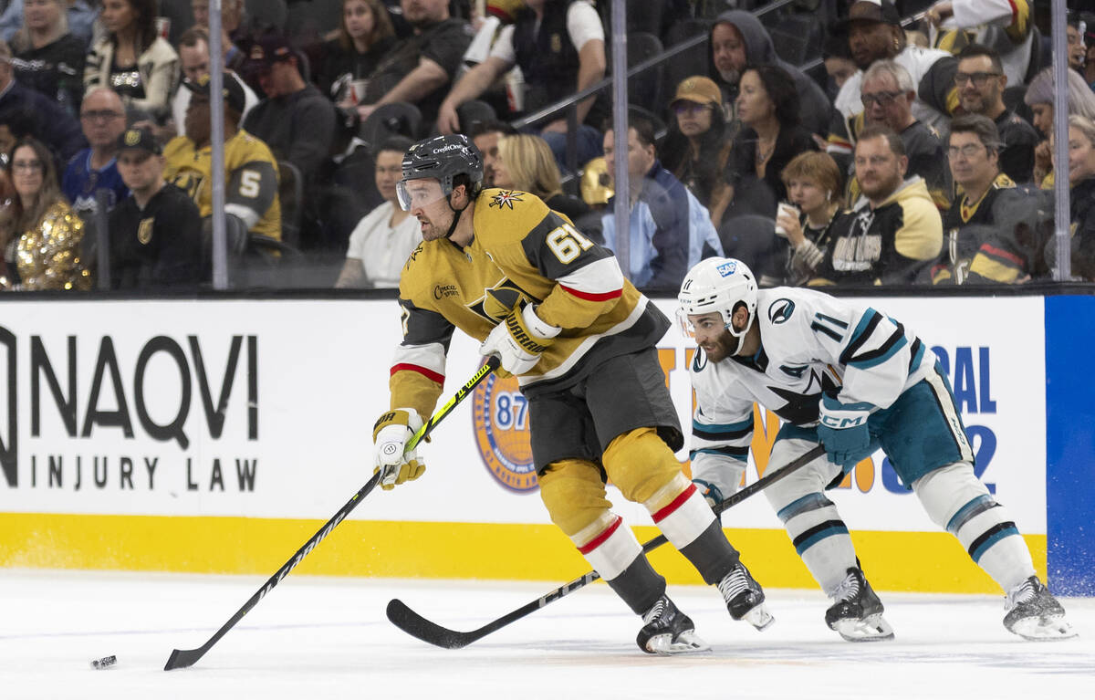 Golden Knights right wing Mark Stone (61) keeps the puck from San Jose Sharks center Luke Kunin ...