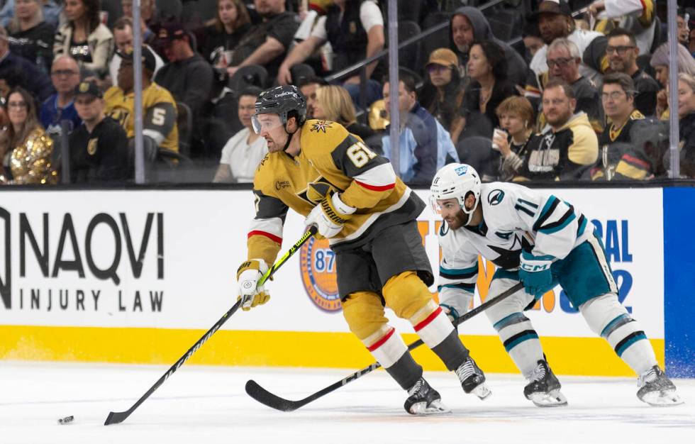 Golden Knights right wing Mark Stone (61) keeps the puck from San Jose Sharks center Luke Kunin ...