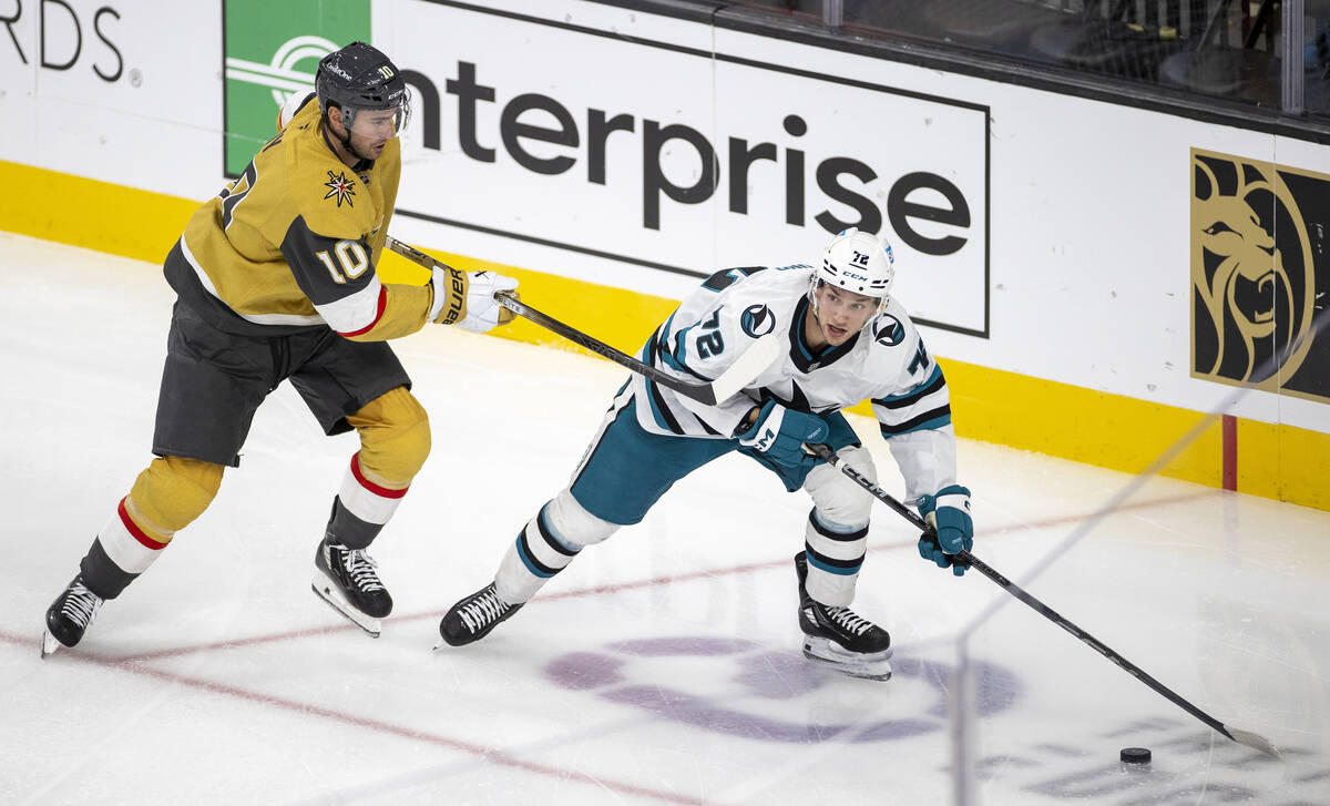 San Jose Sharks left wing William Eklund (72) keeps the puck away from Golden Knights center Ni ...