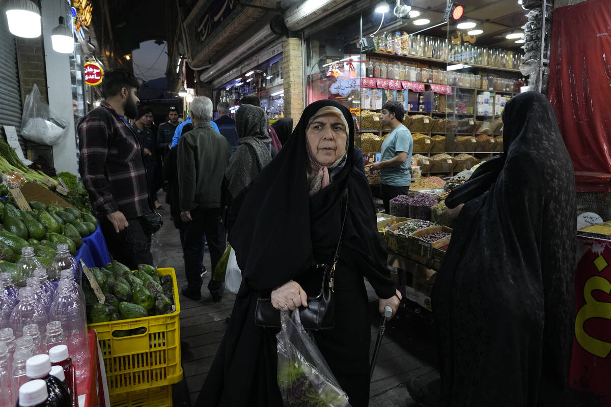 People shop at Tajrish traditional bazaar in northern Tehran, Iran, Saturday, Oct. 26, 2024. (A ...