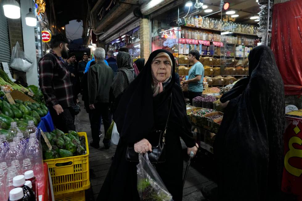 People shop at Tajrish traditional bazaar in northern Tehran, Iran, Saturday, Oct. 26, 2024. (A ...