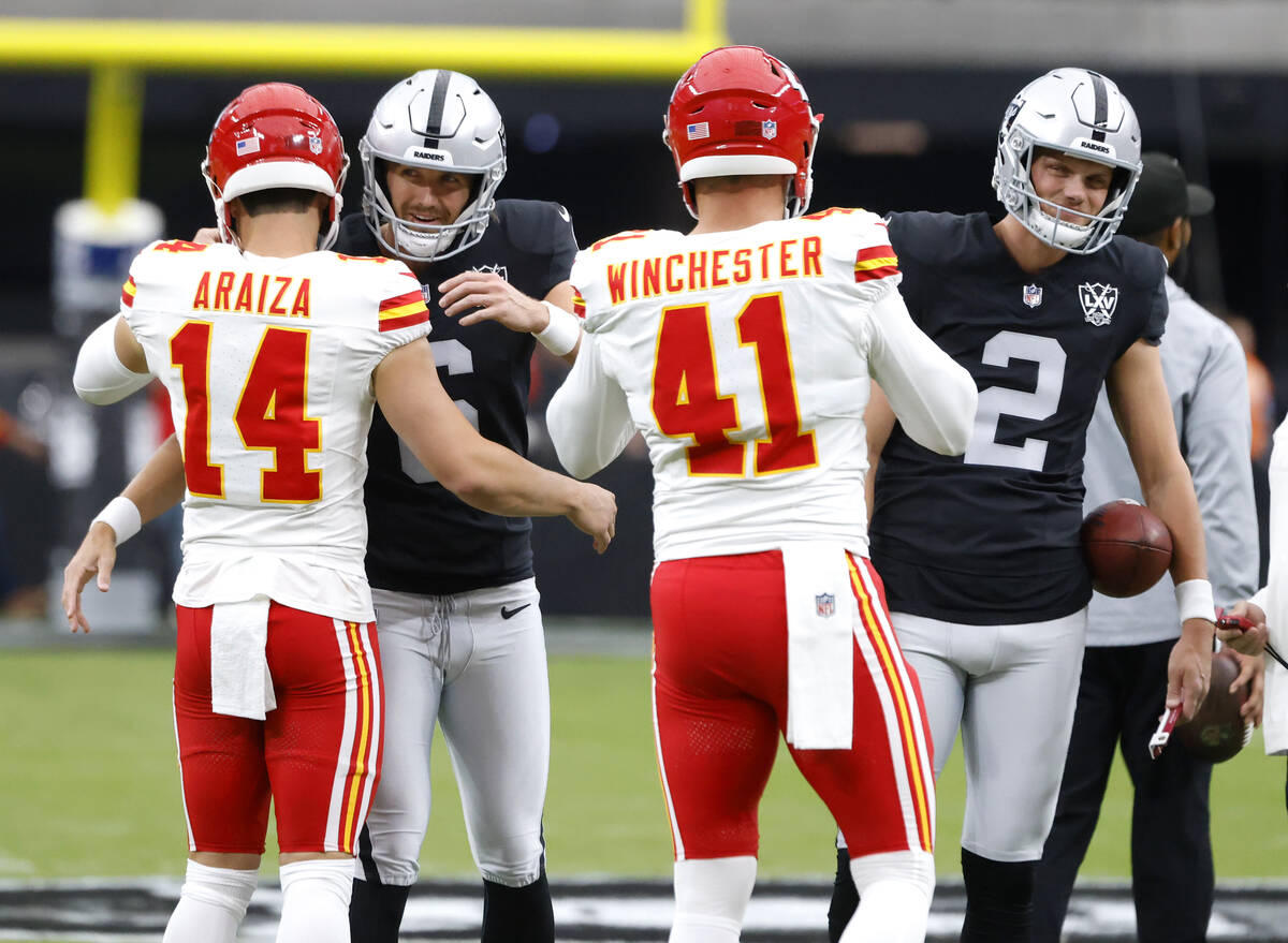 Kansas City Chiefs punter Matt Araiza (14) and long snapper James Winchester (41) greet Raiders ...