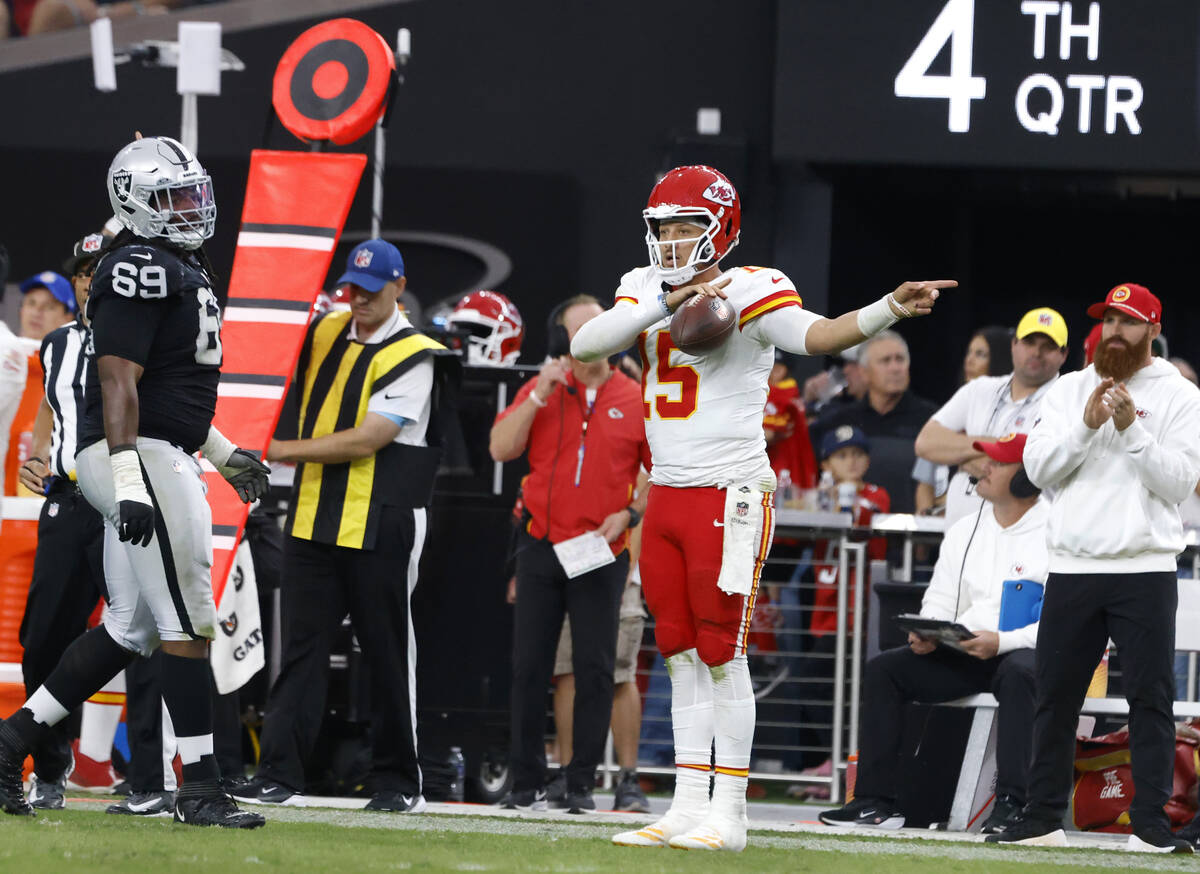 Kansas City Chiefs quarterback Patrick Mahomes (15) signals after a play on first down as Raide ...