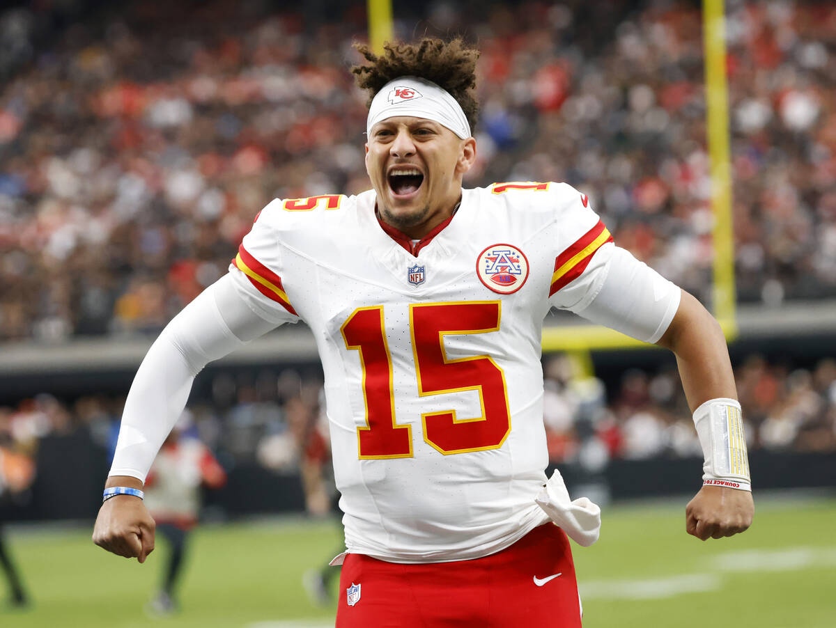 Kansas City Chiefs quarterback Patrick Mahomes (15) pumps up his team before facing Raiders in ...