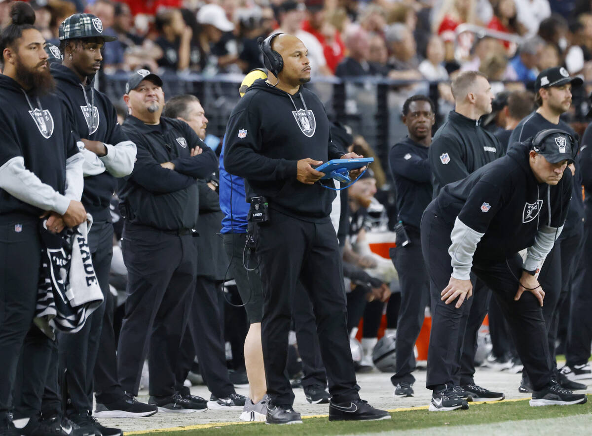 Raiders head coach Antonio Pierce watches the game from the sidelines during an NFL game agains ...