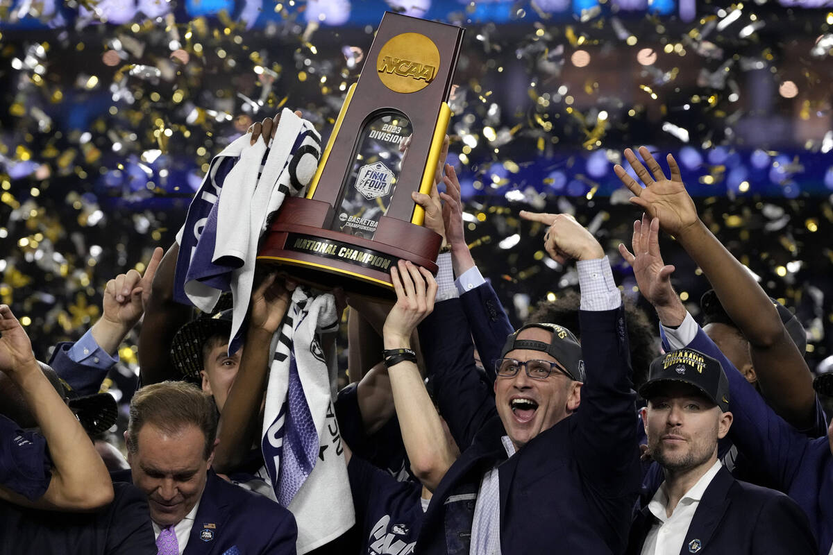 FILE - Connecticut head coach Dan Hurley celebrates with the trophy after their win against San ...