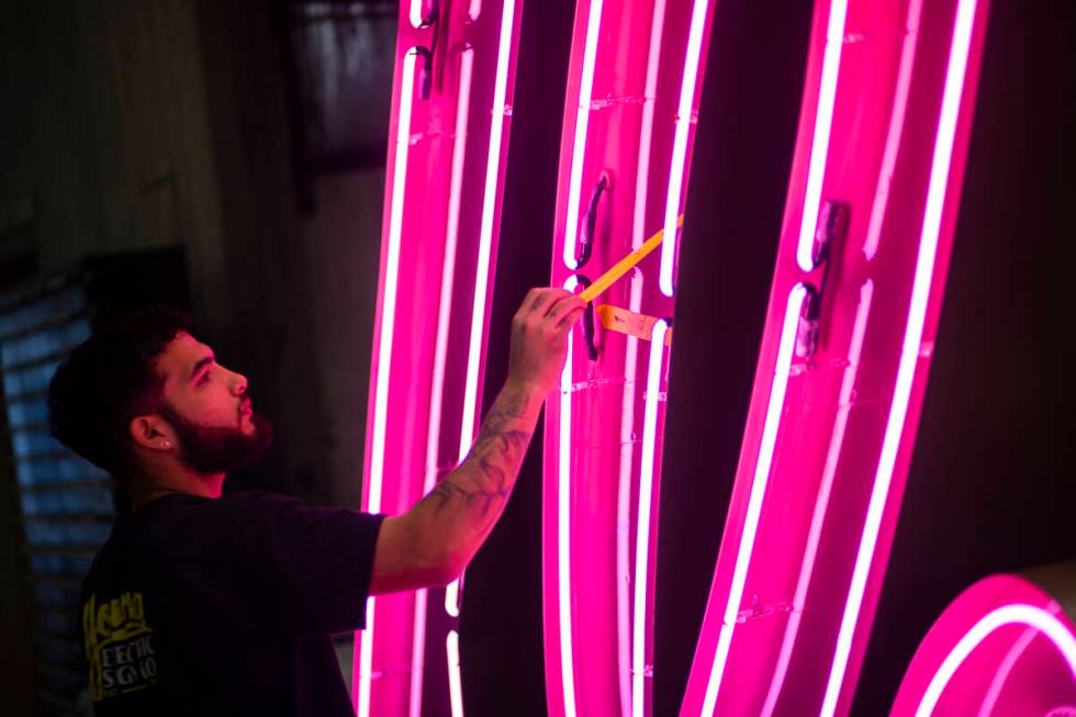 A YESCO employee checks the “Debbie” neon sign, from the former Debbie Reynolds H ...