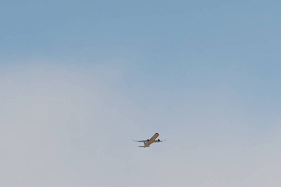 With a dust cloud east of Harry Reid International Airport, a jetliner takes off in Las Vegas o ...