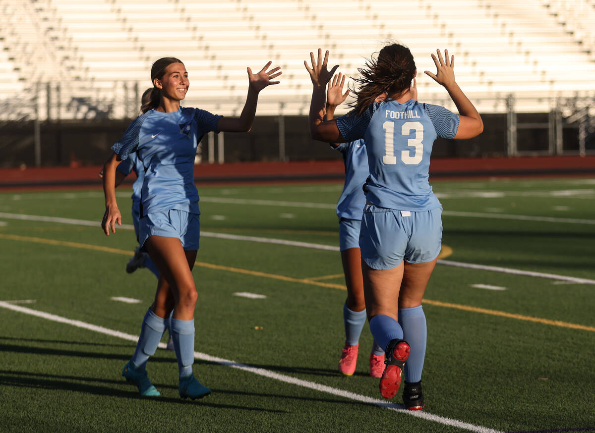 Foothill High School players high-five after earning a point against Southeast Career Technical ...