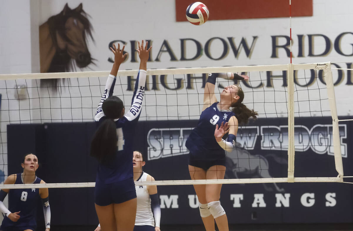 Shadow Ridge’s Briley Fawson (9) looks to spike the ball against Centennial’s Aud ...