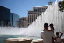 Dragan Cvet holds his daughter Nevi, 7, while watching the Bellagio water fountain show on Fath ...