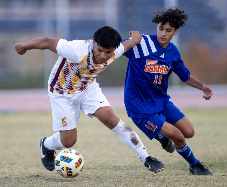 Eldorado midfielder Rogelio Berto, left, and Bishop Gorman midfielder Hector Miranda (11) compe ...