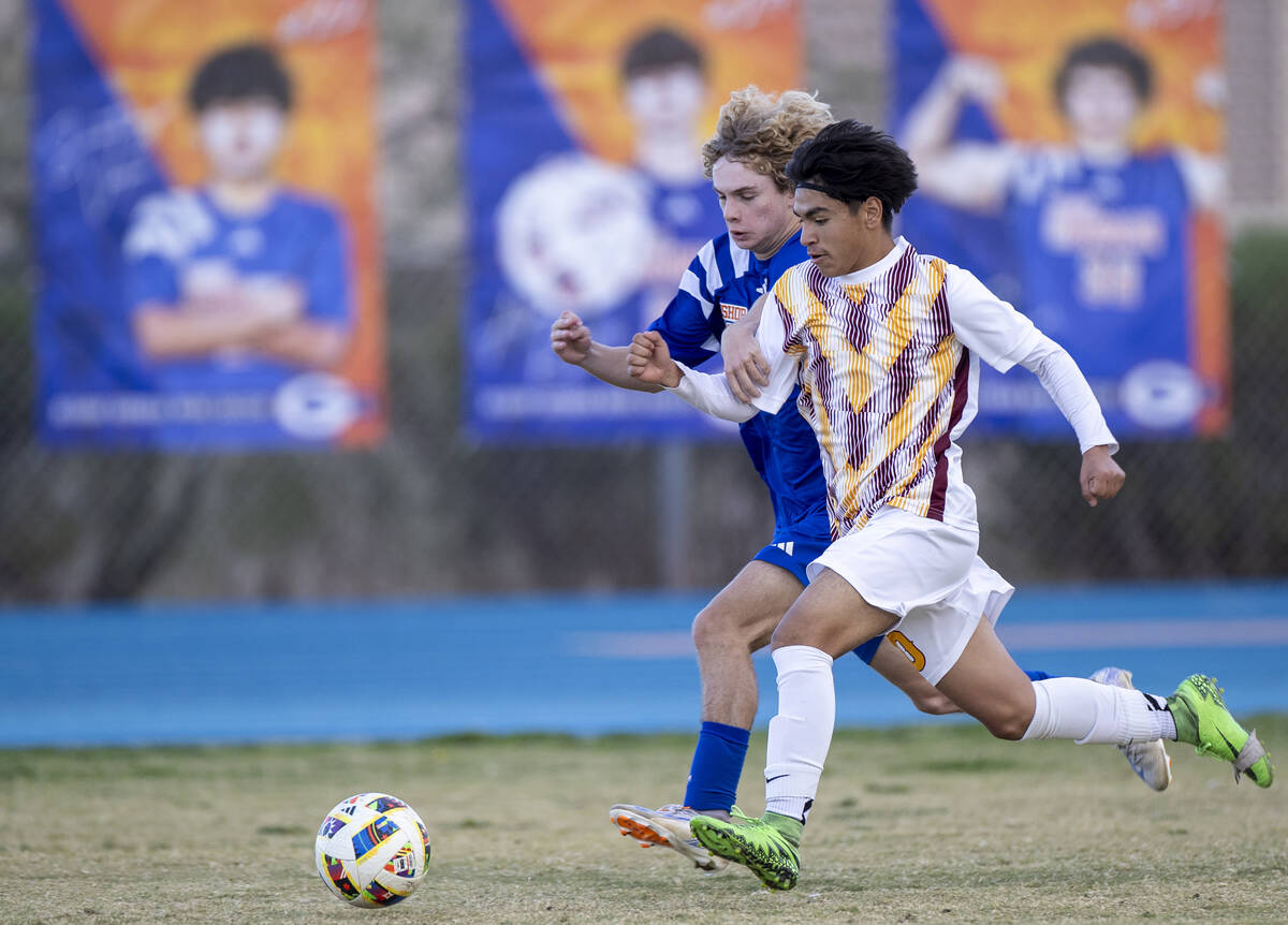 Bishop Gorman defender Torin Davis, back, and Eldorado forward Abraham Chavez, front, chase aft ...