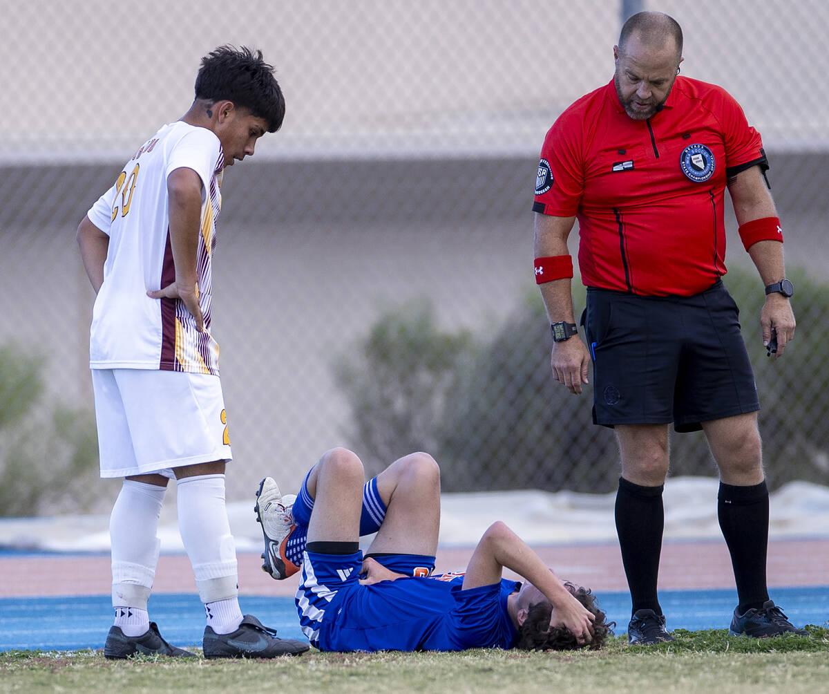 Bishop Gorman defender Maxim Mundson, center, reacts after taking a ball to the groin during th ...