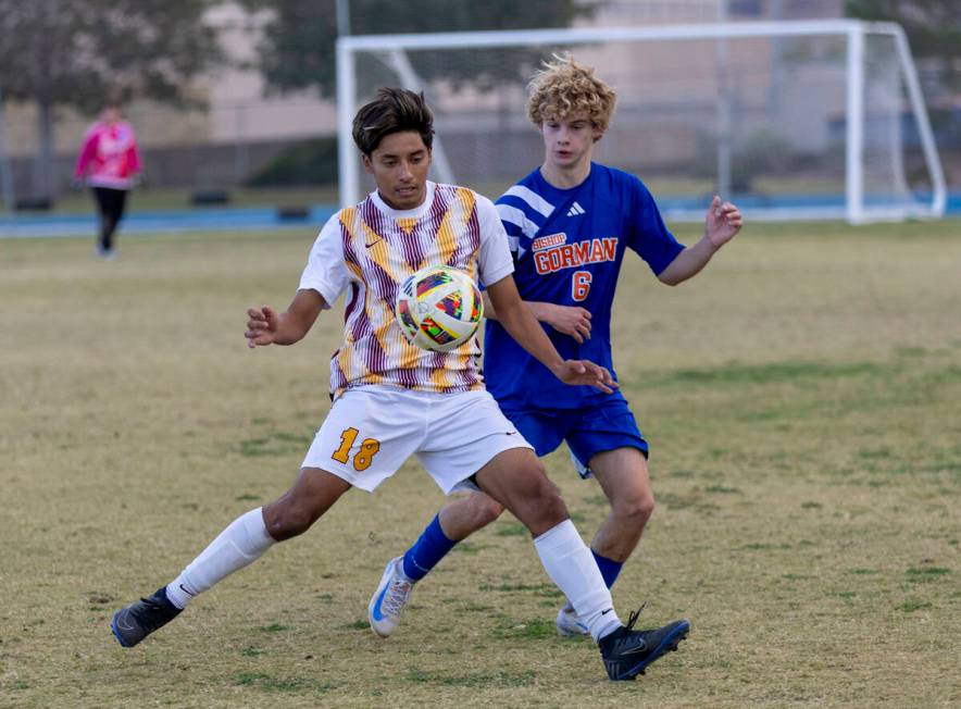 Eldorado senior Henyor Archila (18) and Bishop Gorman defender Torin Davis (6) compete for the ...