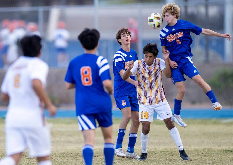 Bishop Gorman defender Torin Davis (6) headbutts the ball during the Class 5A Southern League q ...