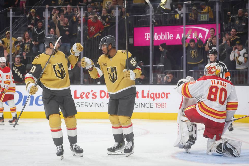 Golden Knights right wing Keegan Kolesar (55) celebrates his goal with Golden Knights center Ni ...