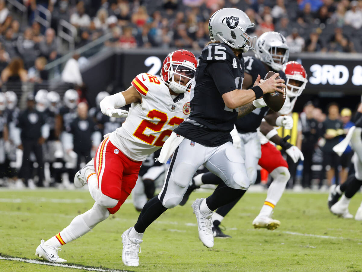 Raiders quarterback Gardner Minshew (15) is chased by Kansas City Chiefs cornerback Trent McDuf ...