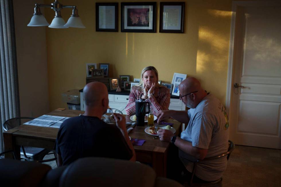 Cari-Ann Burgess, interim Registrar of Voters for Washoe County, Nev., center, eats dinner with ...