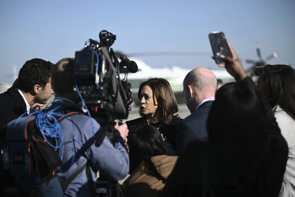 Democratic presidential nominee Vice President Kamala Harris talks to reporters before boarding ...