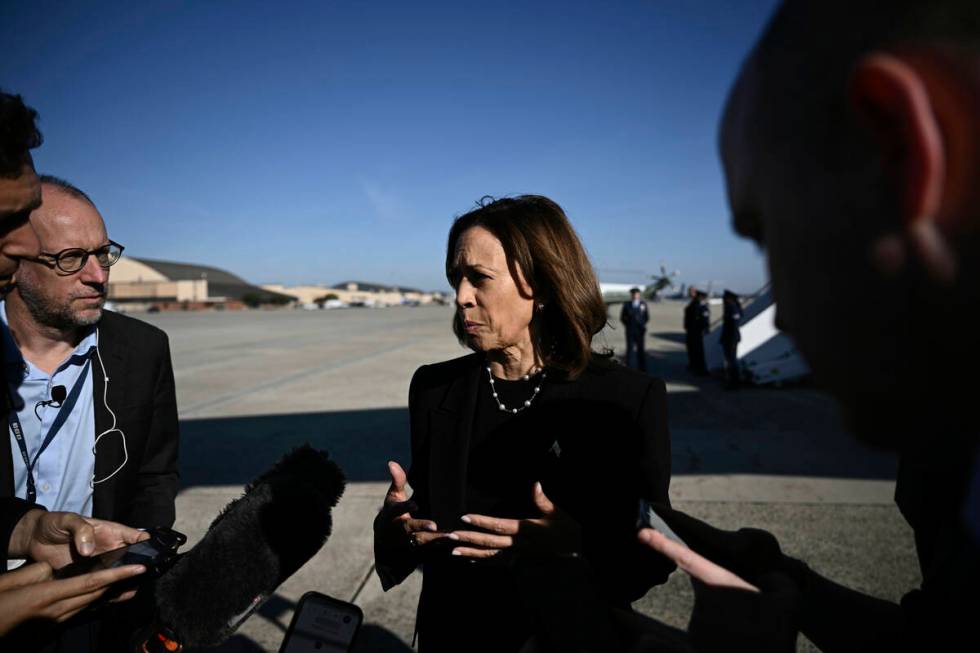 Democratic presidential nominee Vice President Kamala Harris talks to reporters before boarding ...