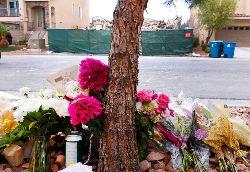 A makeshift memorial is seen in front of a now-mostly demolished house that burned to the groun ...