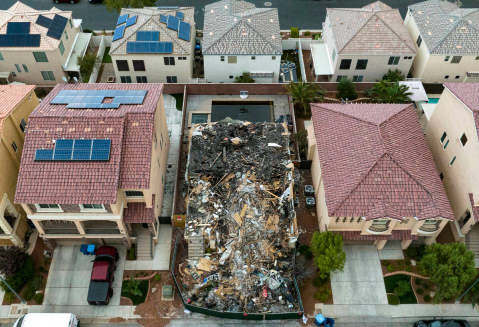 A now-demolished house that burned to the ground days before, killing two adults and two childr ...