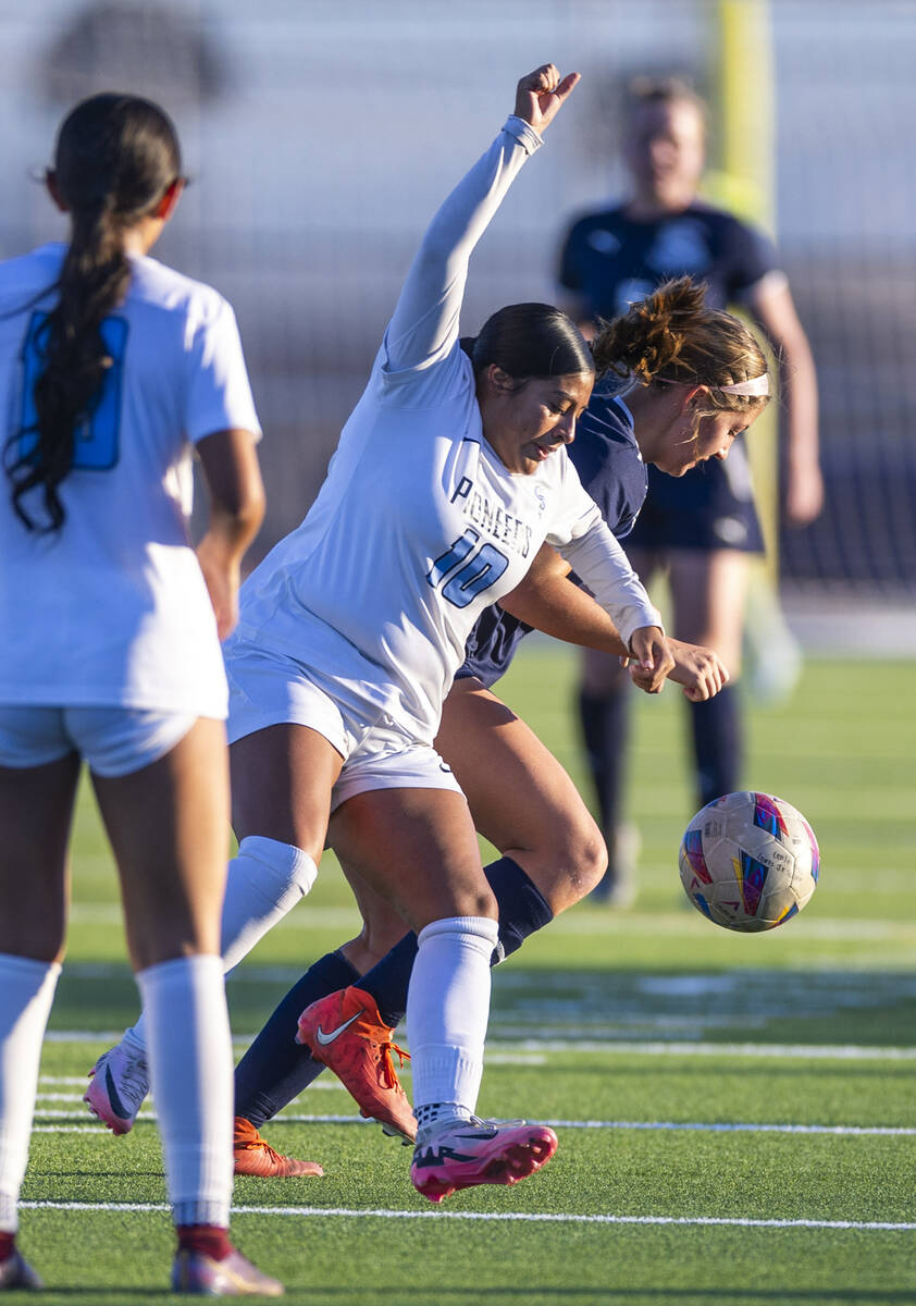 Canyon Springs midfielder Ximena Gonzalez (10) battles to control the ball against Centennial d ...