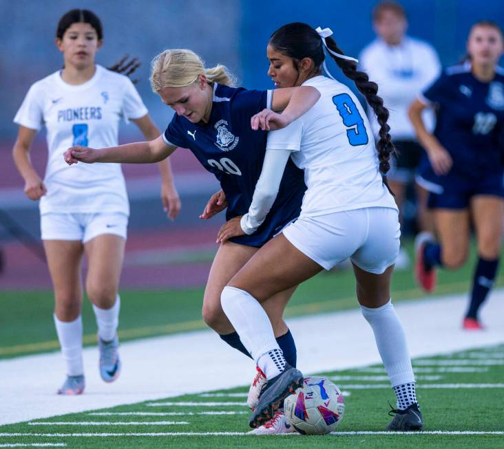 Centennial forward Skyley Mecham (20) attempts to advance the ball past Canyon Springs defender ...