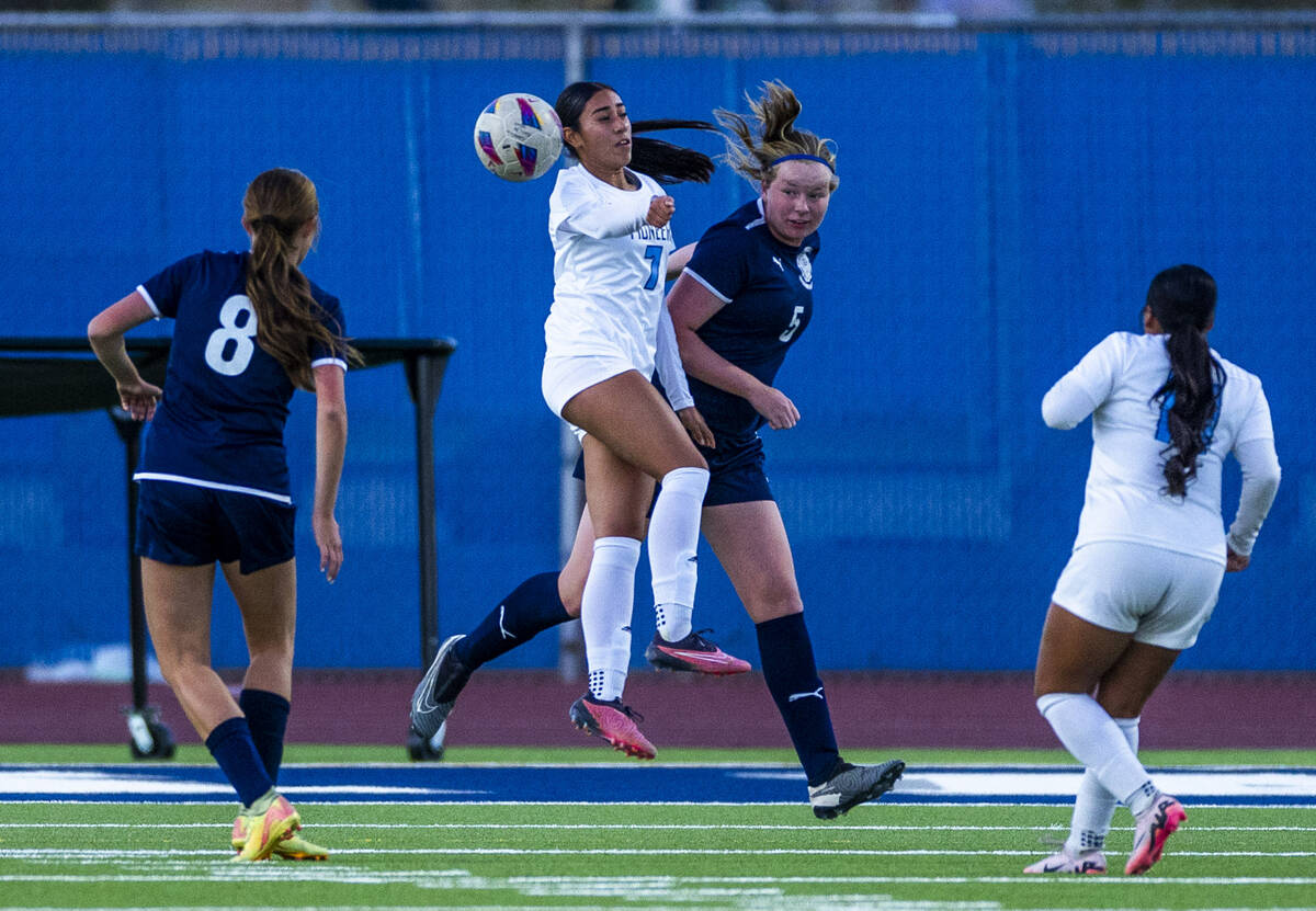 Centennial defender Fee van Zoghe (5) heads the ball away from Canyon Springs midfielder Daniel ...