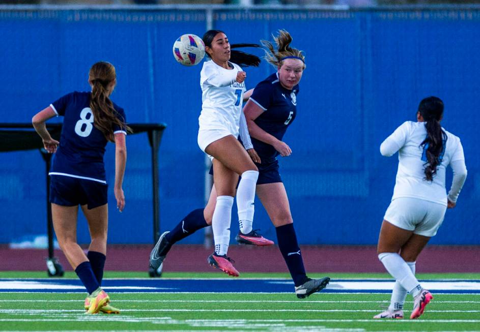 Centennial defender Fee van Zoghe (5) heads the ball away from Canyon Springs midfielder Daniel ...