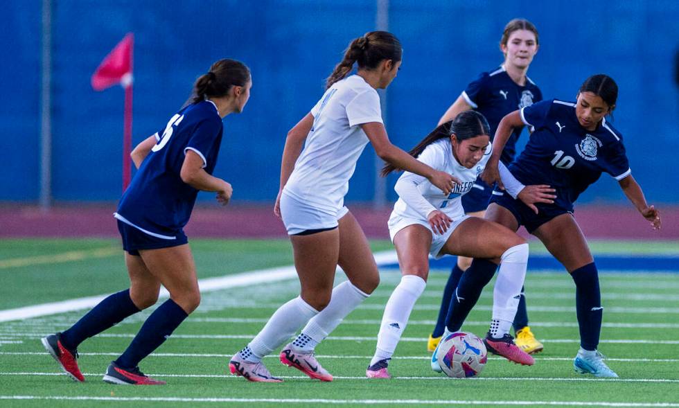 Canyon Springs midfielder Daniela Mayorga (7) keeps Centennial midfielder Alexandra Miranda (10 ...