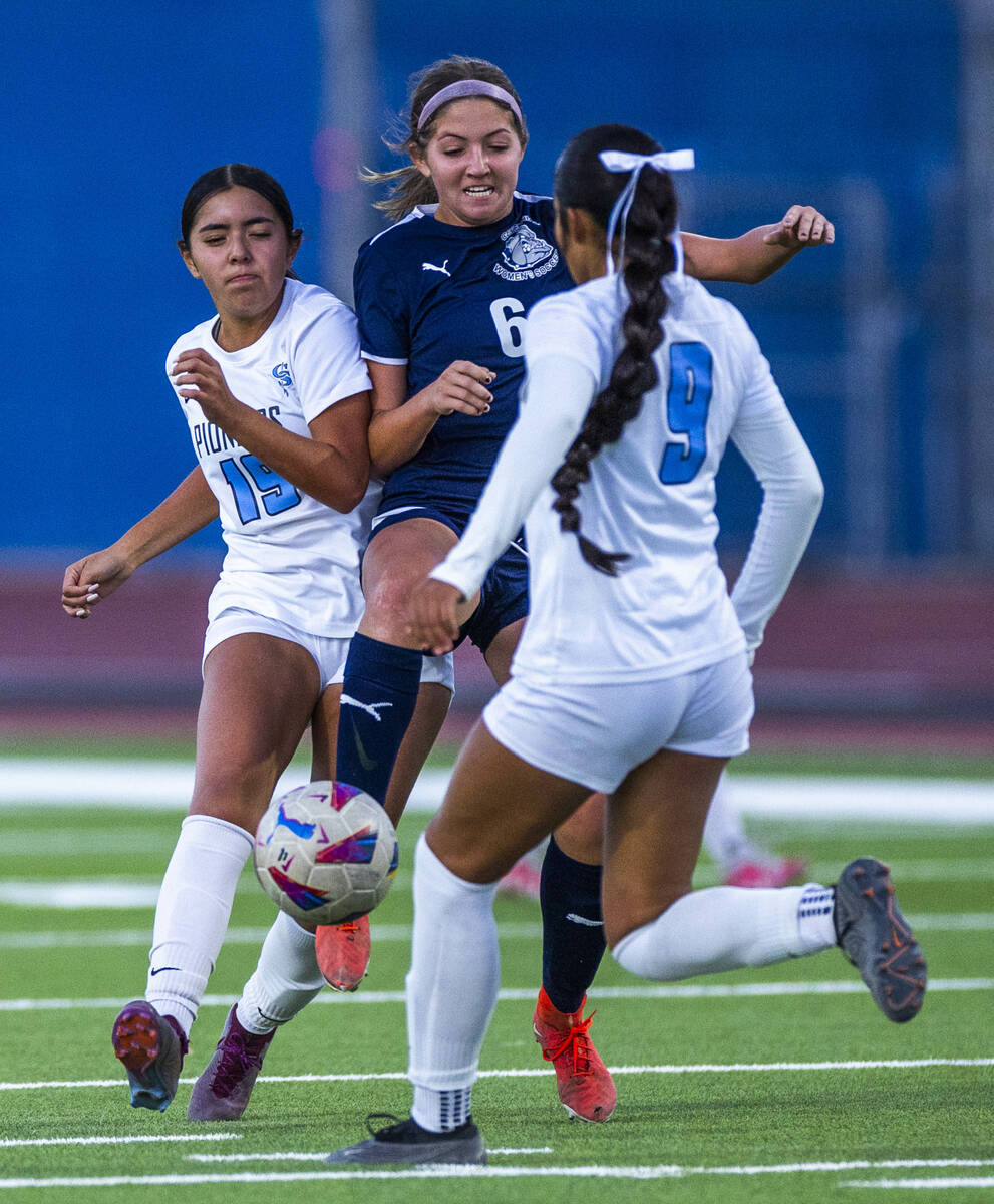 Centennial defender Ellah Scharringhausen (6) advances the ball while fighting off Canyon Sprin ...