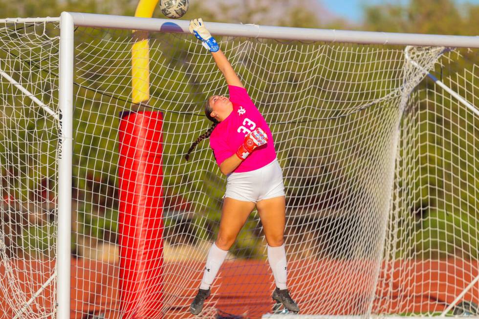 Arbor View goalkeeper Emily Marks (33) reaches to save the ball as it flies over the net during ...