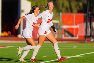 Coronado teammates Mia Schlachter (16) and Cate Gusick (20) celebrate a goal during a Class 5A ...