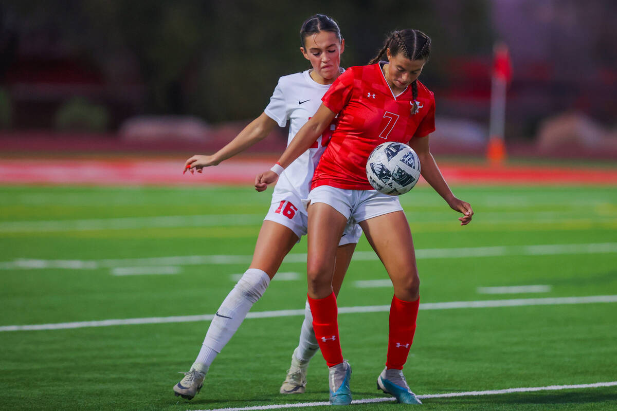 Arbor View forward Layla Lindsey (7) kicks the ball up as Coronado defender Mia Schlachter (16) ...