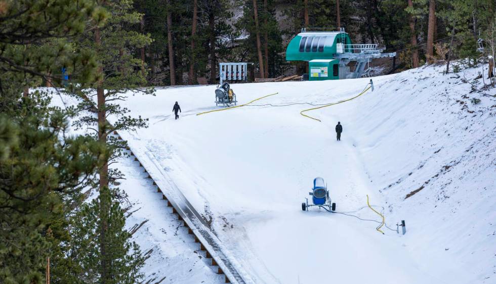 Operations staff walk along a slope as snow is beginning to be made at Lee Canyon on Thursday, ...