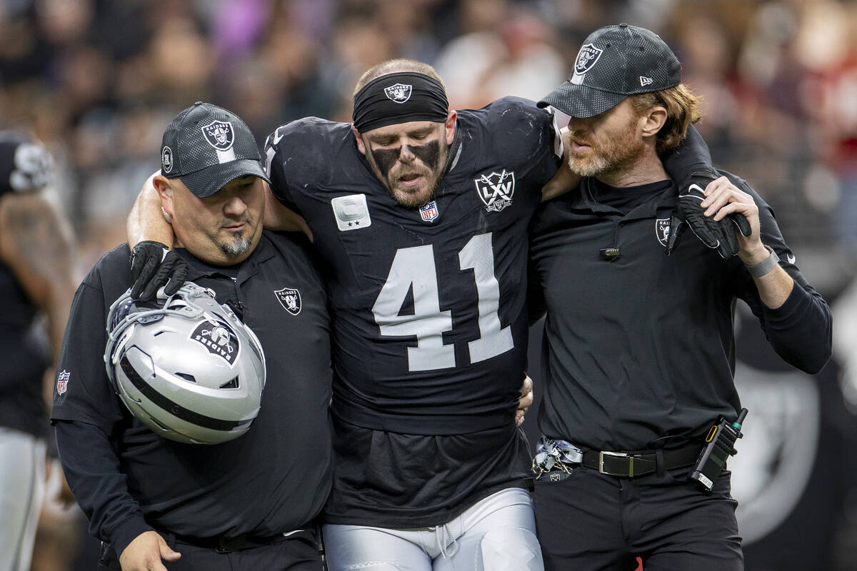 Raiders linebacker Robert Spillane (41) is helped off the field during the first half of the NF ...