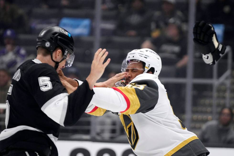 Los Angeles Kings' Andreas Englund, left, and Vegas Golden Knights' Keegan Kolesar fight during ...